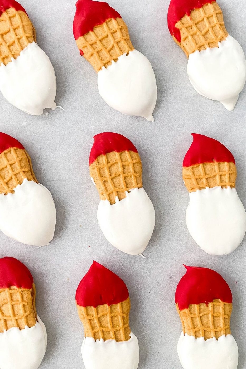 nutter butter santa cookies on parchment paper