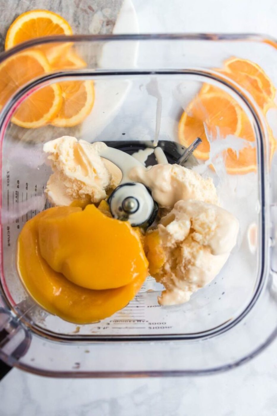 frozen orange juice and ice cream in a blender