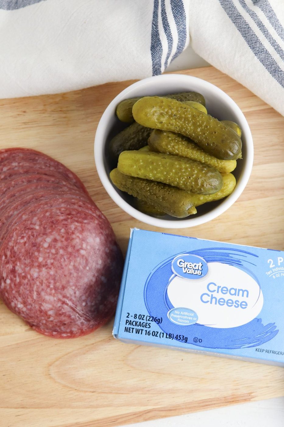 salami roll ups ingredients on cutting board 
