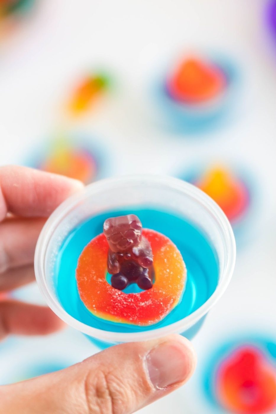 holding vodka jello shot in hand