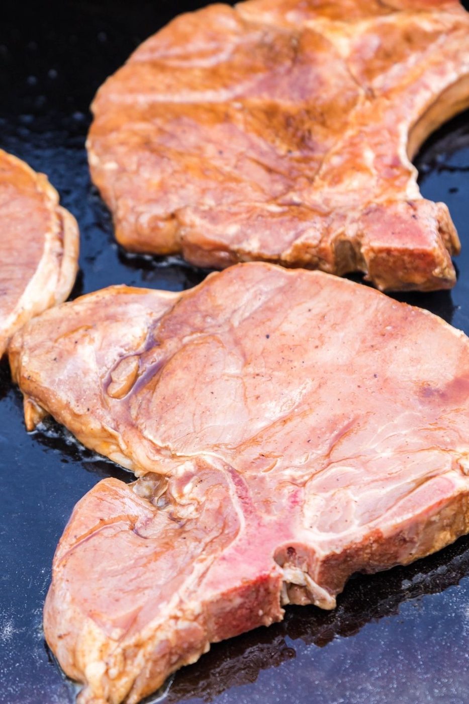 raw pork chops on griddle