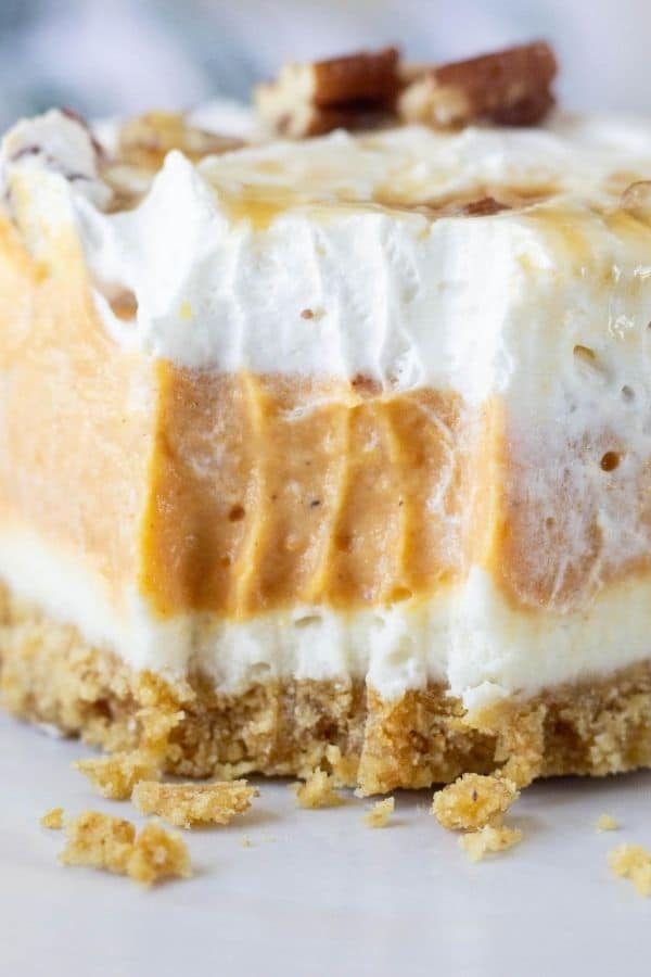 pumpkin fluff dessert on a plate with a bite taken out of it 