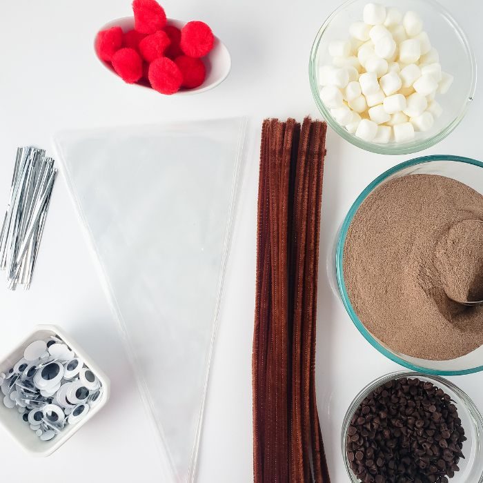 ingredients for reindeer hot chocolate bags on white table