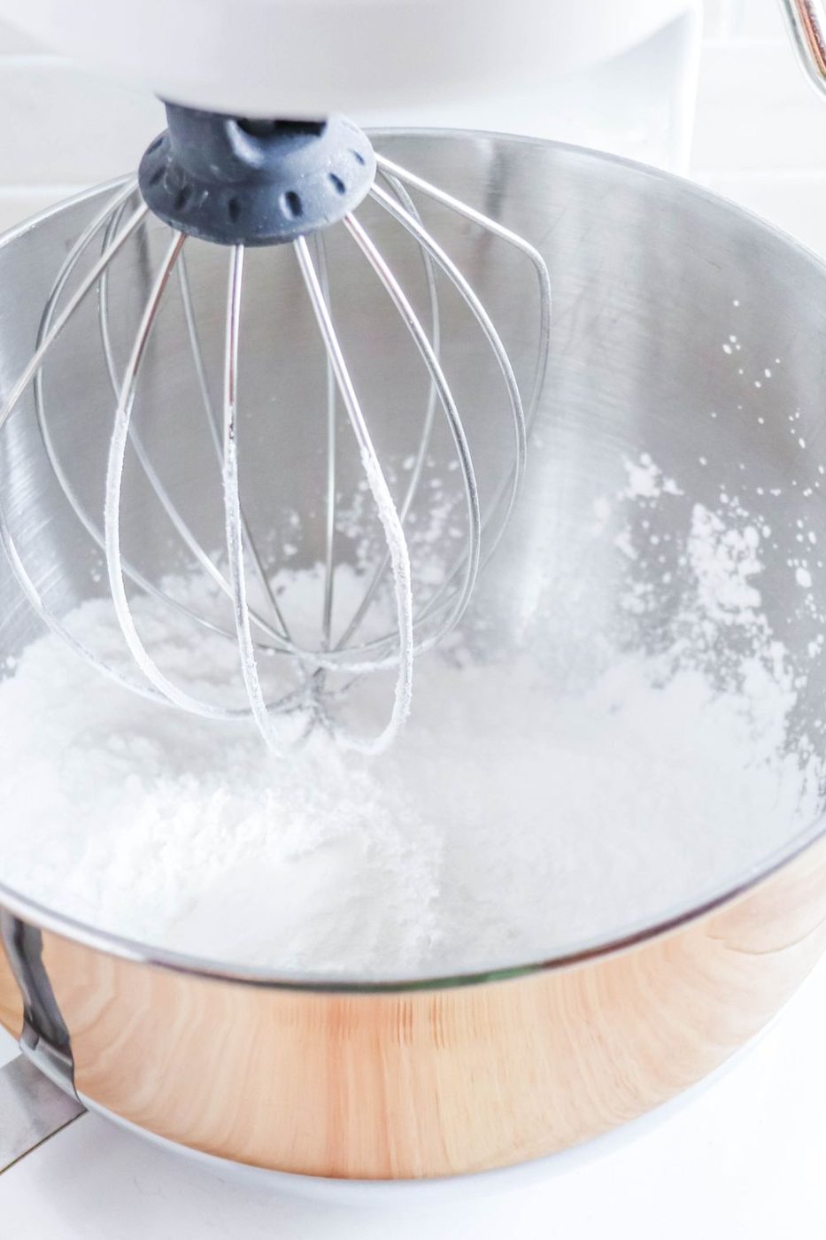stand mixer with powdered sugar pouring in 