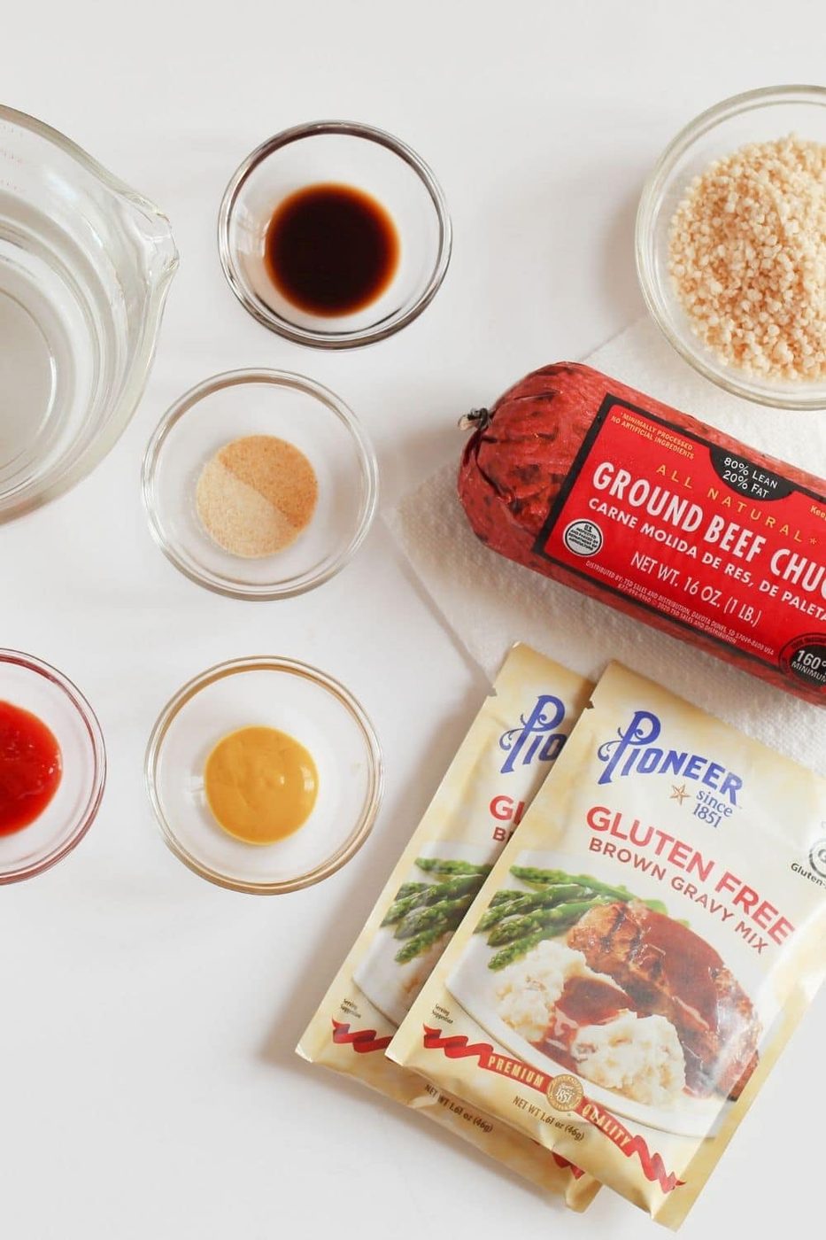overhead shot of ingredients for smothered steaks on white counter 