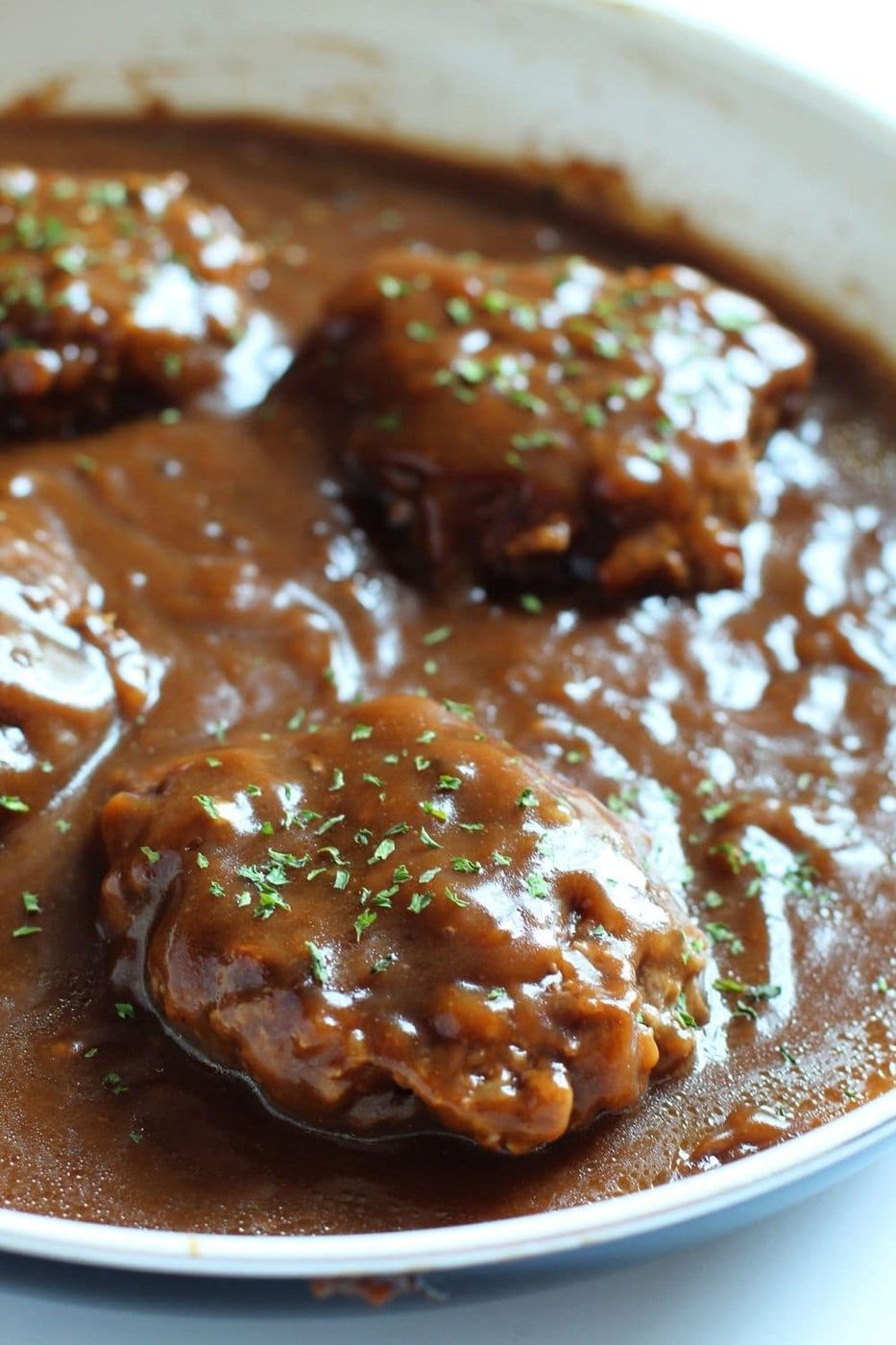 pan with salisbury steak in it 