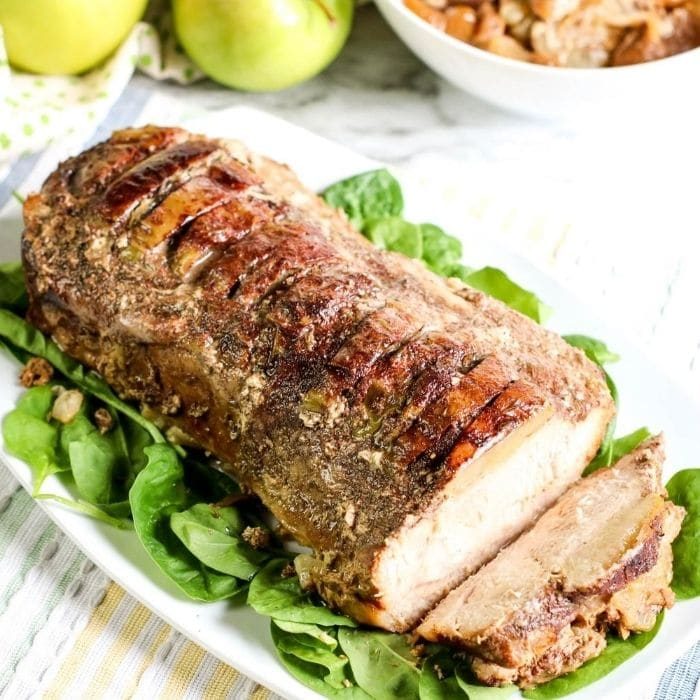 crockpot pork loin on platter with greens