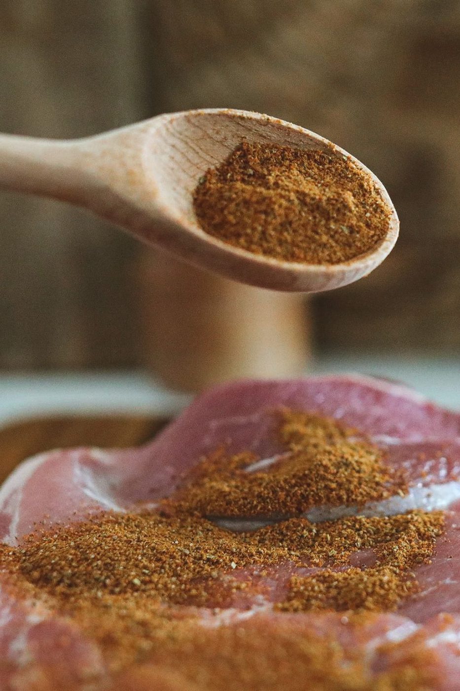adding blackening seasoning on pork roast
