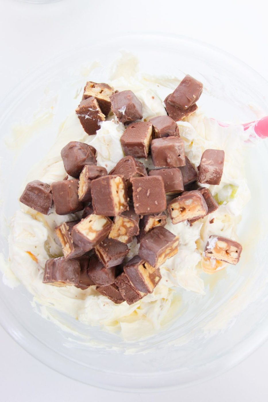 diced snickers in apple salad in bowl