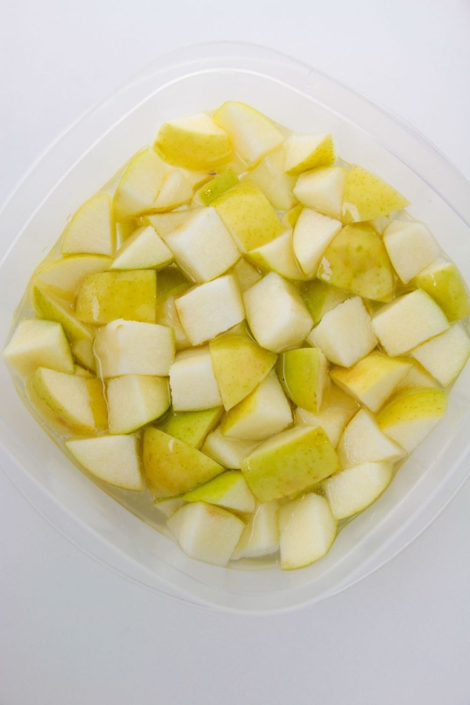 apples in lemon lime soda in a plastic container