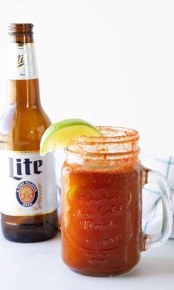 beer on a table with bottle behind it 