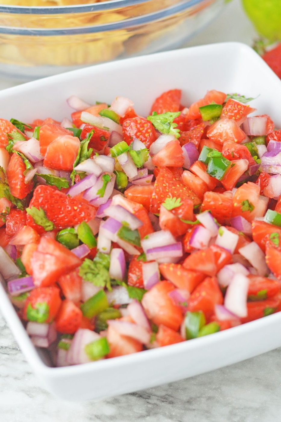 white square bowl with strawberry diced salsa