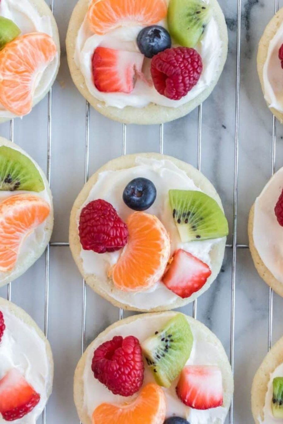 fruit pizzas placed on a cooling rack in even rows 