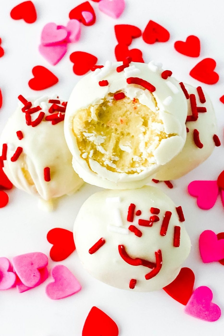 bitten truffle on pile with heart sprinkles around 
