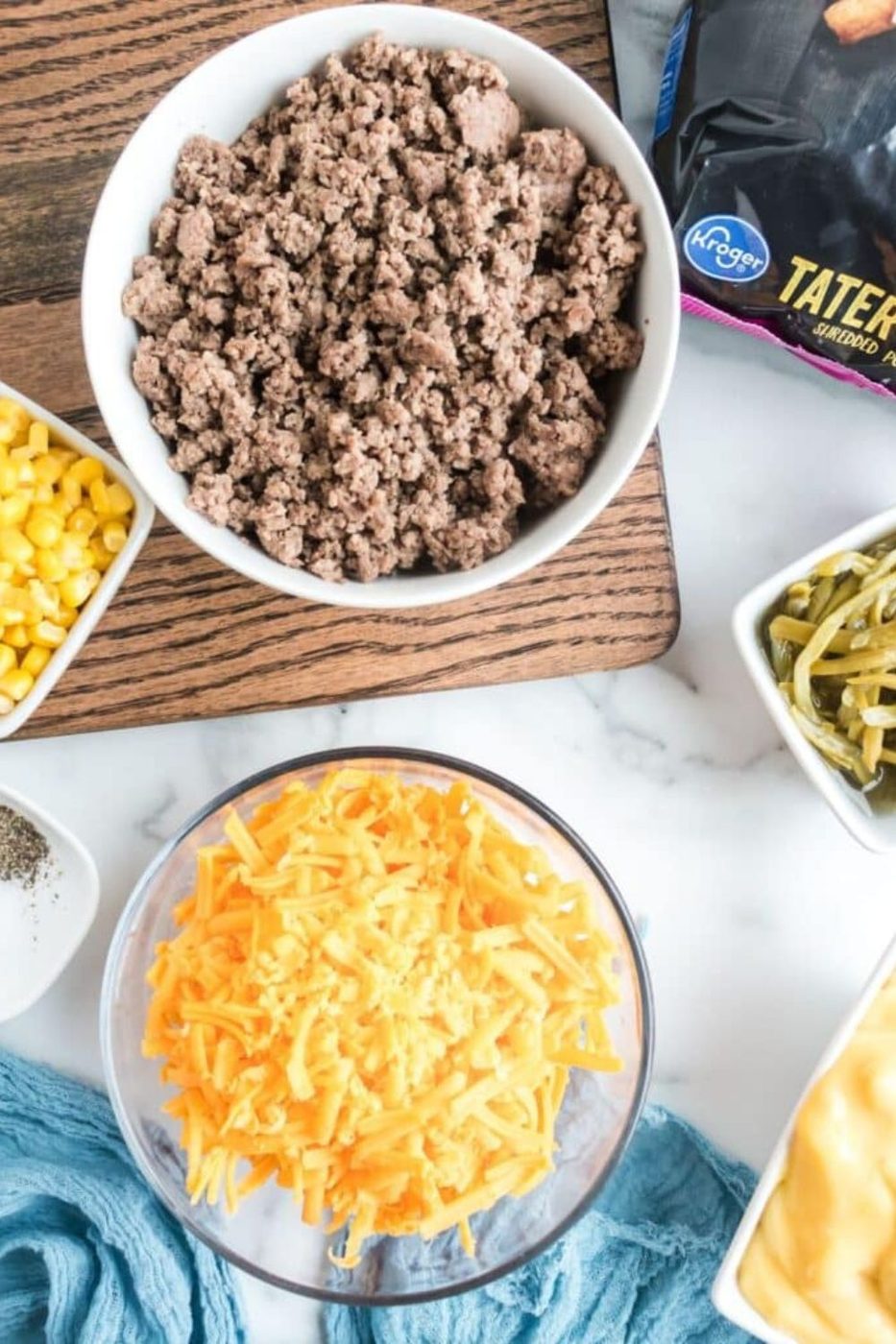 ingredients for Tater Tot Casserole in single bowls on table 