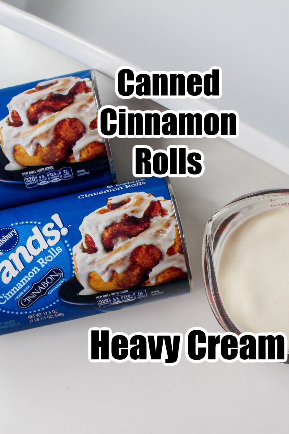 cinnamon rolls and heavy cream in measuring cup 