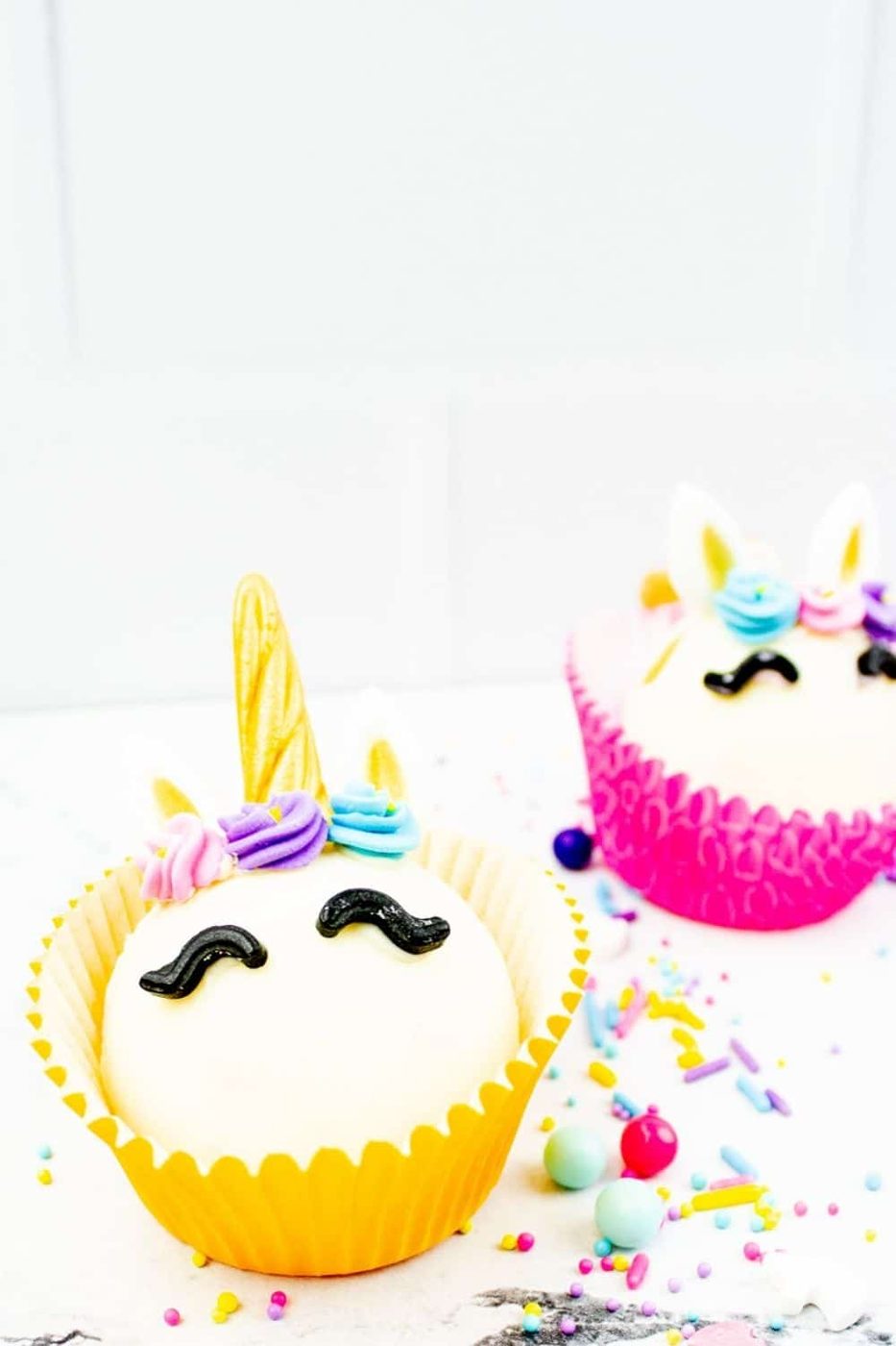yellow and pink cocoa unicorn bombs on white table