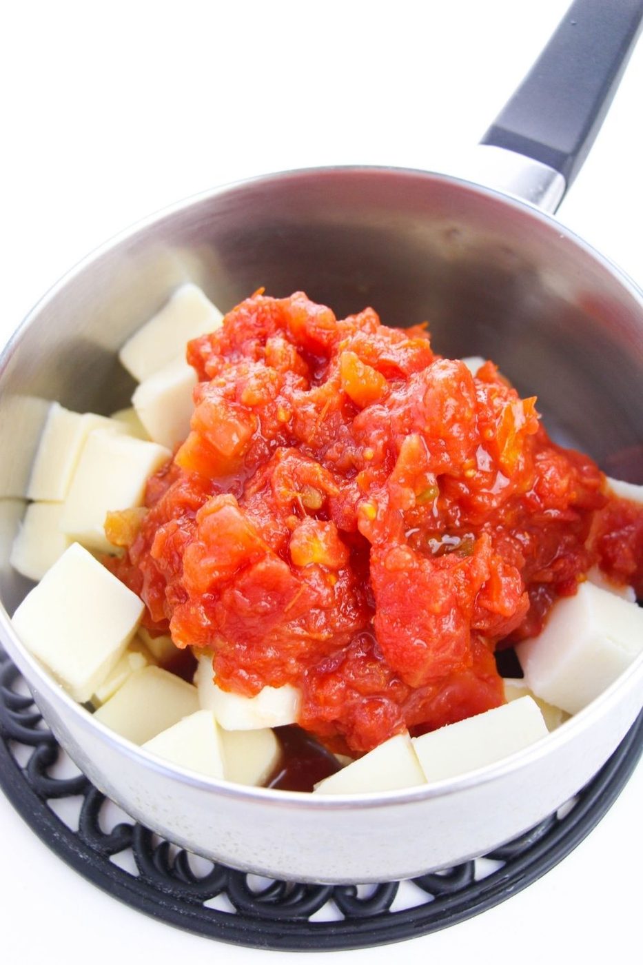 rotel dip on top of diced velveeta cheese in pan 