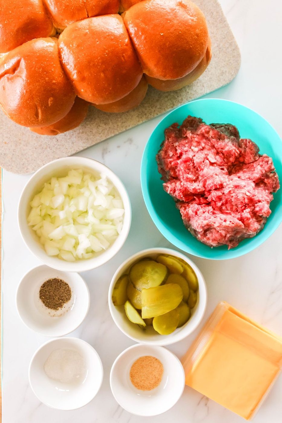 ingredients of burgers in bowls on table 