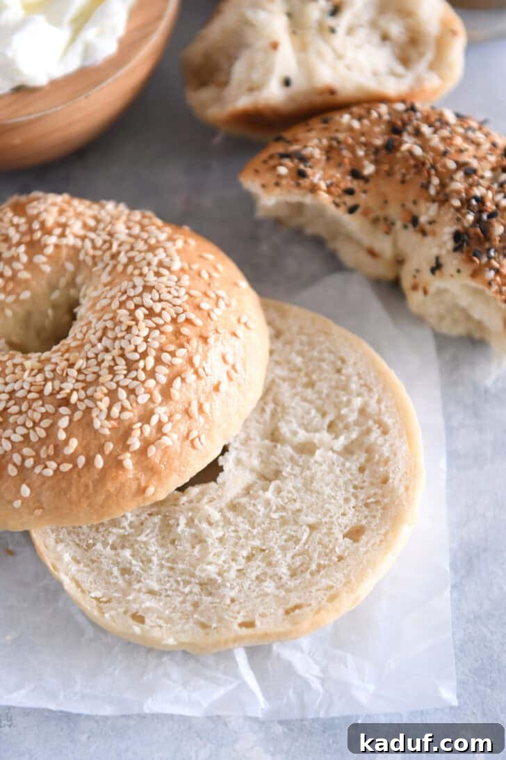 The Ultimate Homemade Bagel Recipe 13 Homemade bagel topped with sesame seed and cut in half.