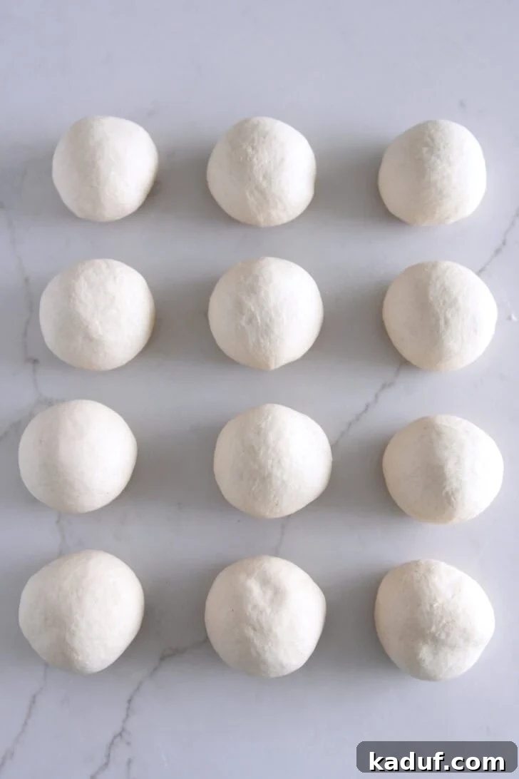 The Ultimate Homemade Bagel Recipe 5 12 round dough balls on white counter.