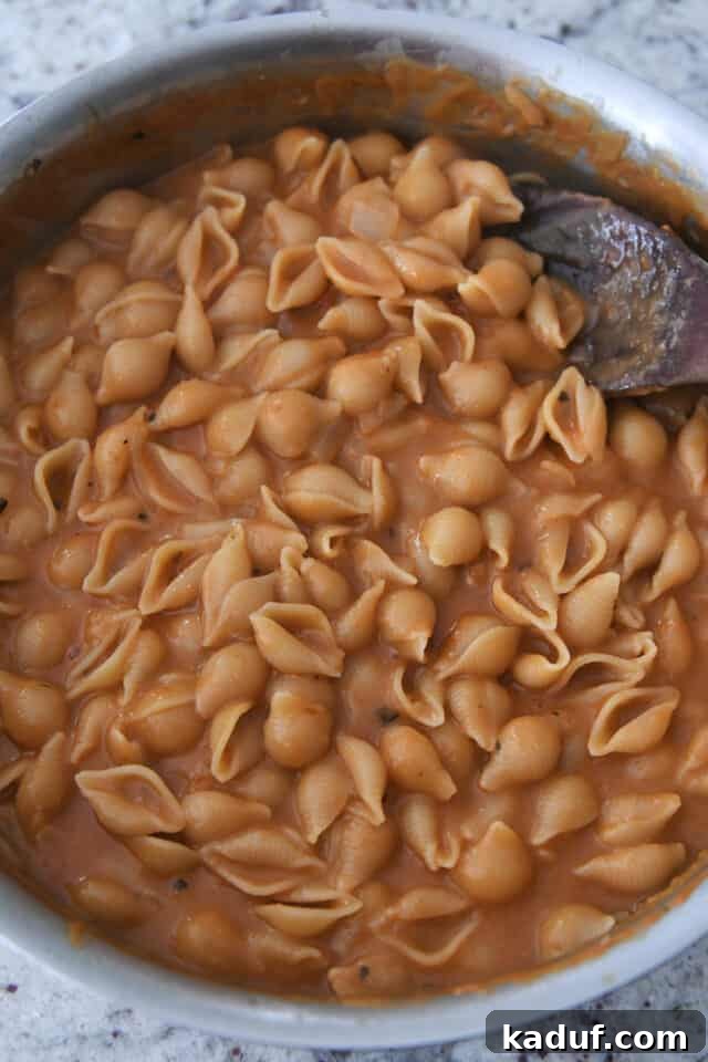 Tuscan Creamy Skillet Pasta 4 Creamy cooked pasta shells in a deep skillet, showing the perfect saucy consistency.
