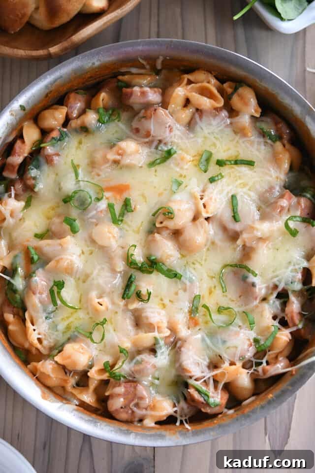Tuscan Creamy Skillet Pasta 7 Top down view of bubbly, melted cheese baked on top of pasta shells and sauce.