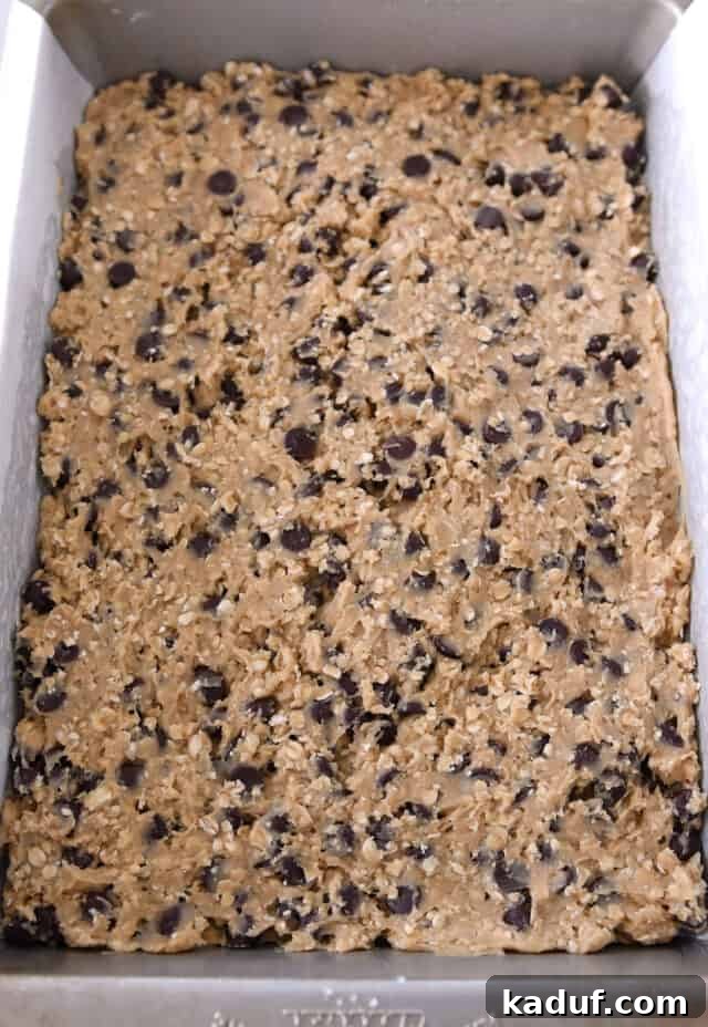 Golden Oat Chocolate Chip Squares 6 Oatmeal chocolate chip cookie dough pressed into a 9x13-inch baking pan, ready to bake.