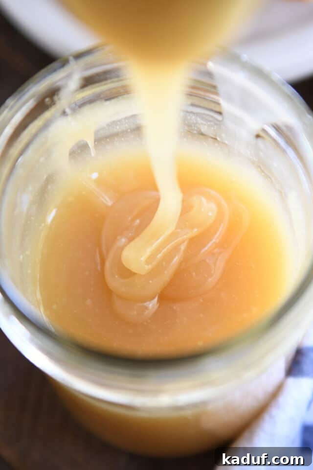 Sweet Tangy Buttermilk Caramel 2 Caramel syrup drizzling into glass jar.
