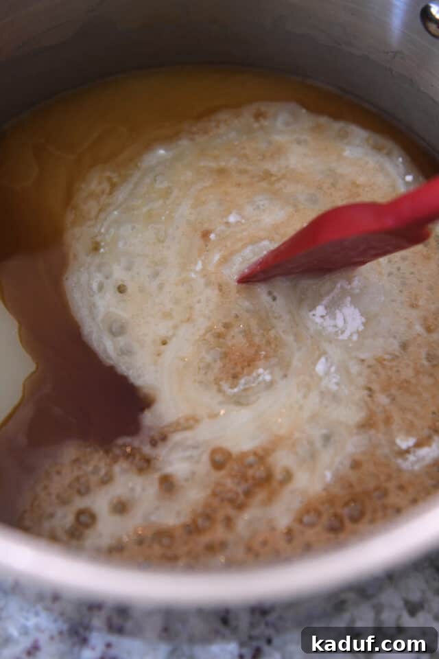 Sweet Tangy Buttermilk Caramel 5 Stirring vanilla and baking soda into syrup in saucepan.