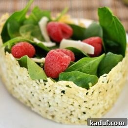 Asiago Crisped Spinach and Raspberry Salad presented in an edible cheese bowl