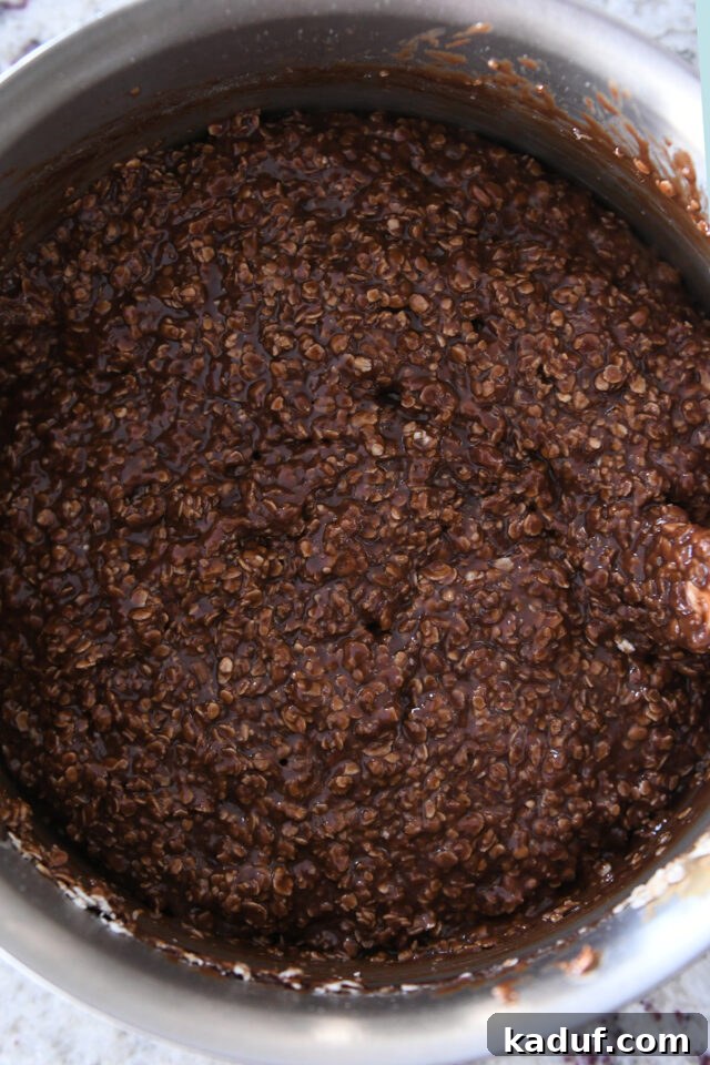 No bake chocolate peanut butter cookie batter in saucepan, ready to be shaped.