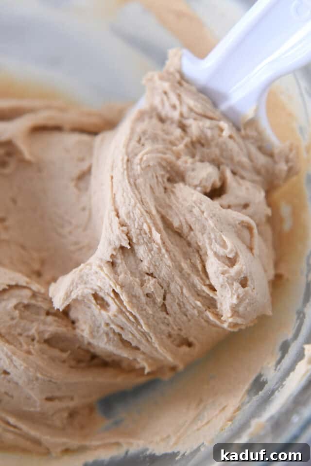 Glass bowl filled with creamy, fluffy peanut butter frosting.
