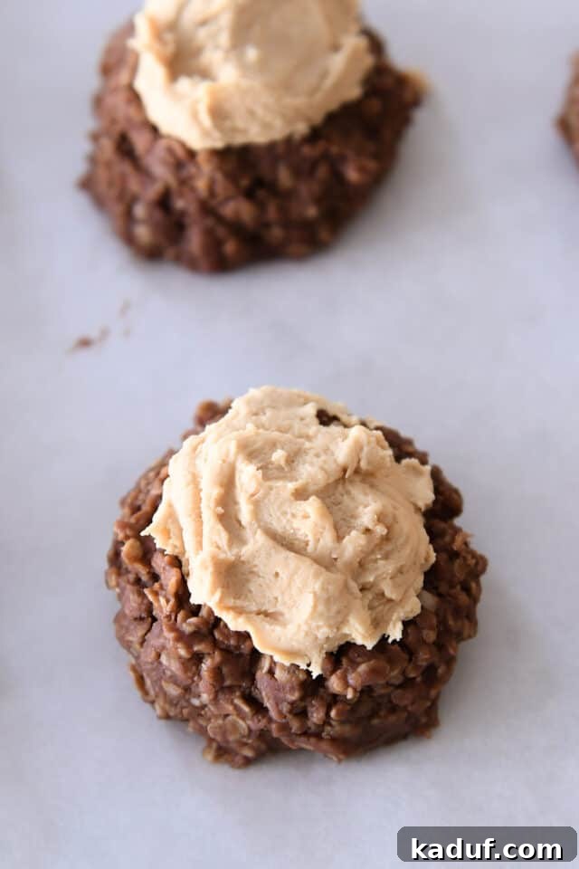 No bake chocolate cookie with a dollop of creamy peanut butter frosting in the center.