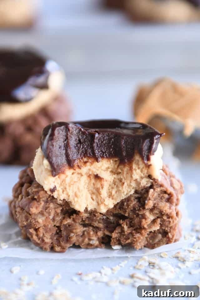 A no-bake chocolate peanut butter buckeye cookie with a bite taken out, showing the layers.