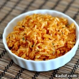 A vibrant bowl of homemade Mexican rice, garnished with fresh cilantro.