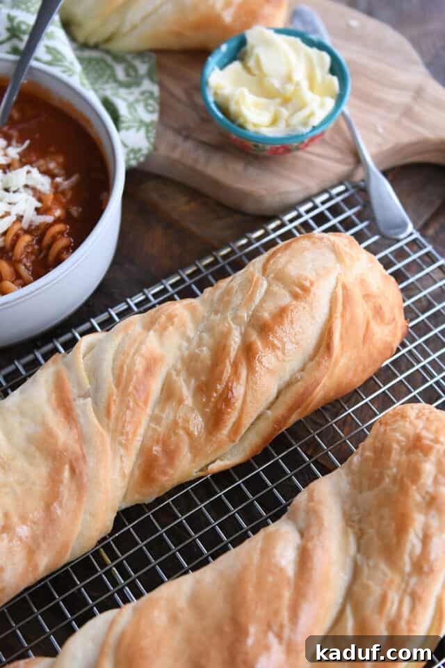 Effortless Twisted Croissant French Bread 2 Two loaves of twisted croissant French bread on wire rack.