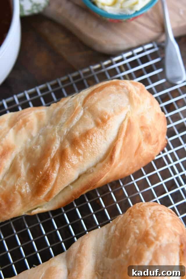 Effortless Twisted Croissant French Bread 14 Buttery croissant French bread on cooling rack.