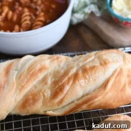 Effortless Twisted Croissant French Bread 15 Loaf of twisted croissant French bread on cooling rack.