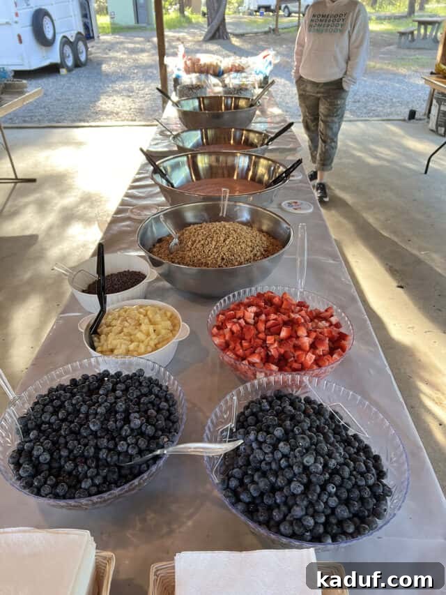 Camp Kitchen Secrets Menus Tips and Resources for Feeding Big Groups 11 Yogurt parfait ingredients set out on table outside.