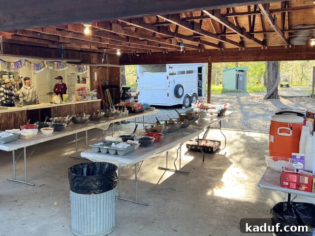 Camp Kitchen Secrets Menus Tips and Resources for Feeding Big Groups 10 Tables set up outside with food for breakfast.