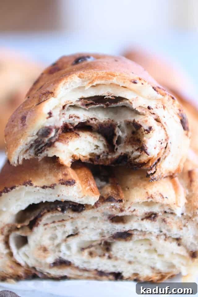 French Chocolate Swirl Bread 15 Close-up of flaky chocolate croissant French bread, showing the rich layers and tempting chocolate.