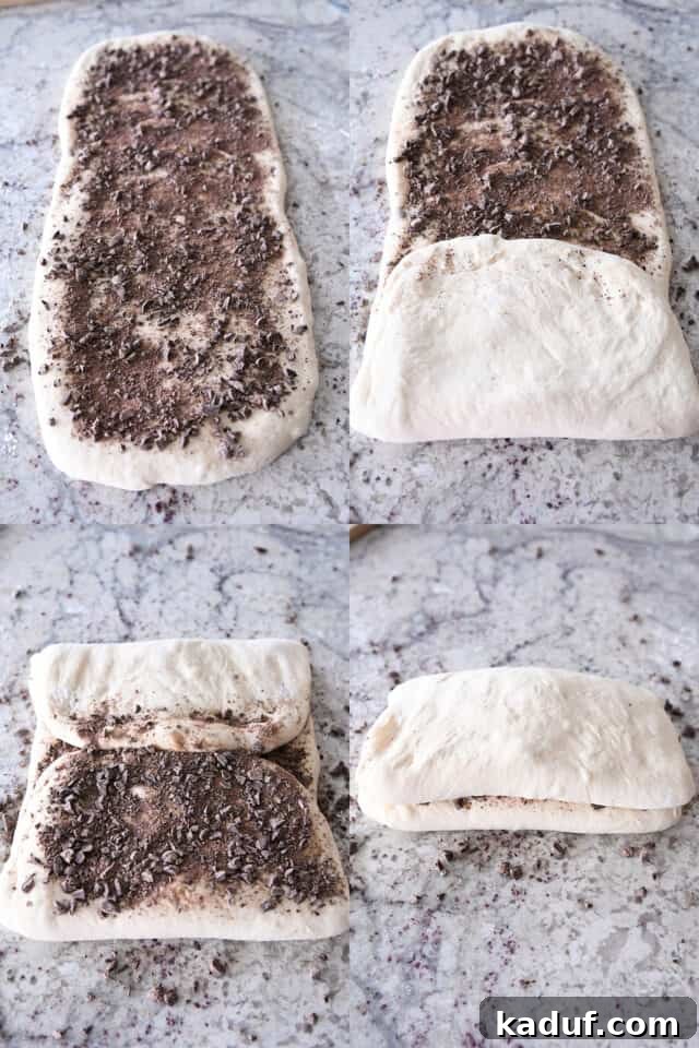 French Chocolate Swirl Bread 8 Folding up French bread dough over scattered chopped chocolate, creating layers of dough and chocolate.