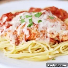 A close-up shot of Skillet Chicken Parmesan, garnished with fresh herbs.
