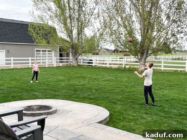 Weekend Contemplations 2 Two kids playing football in back yard, enjoying outdoor family time.
