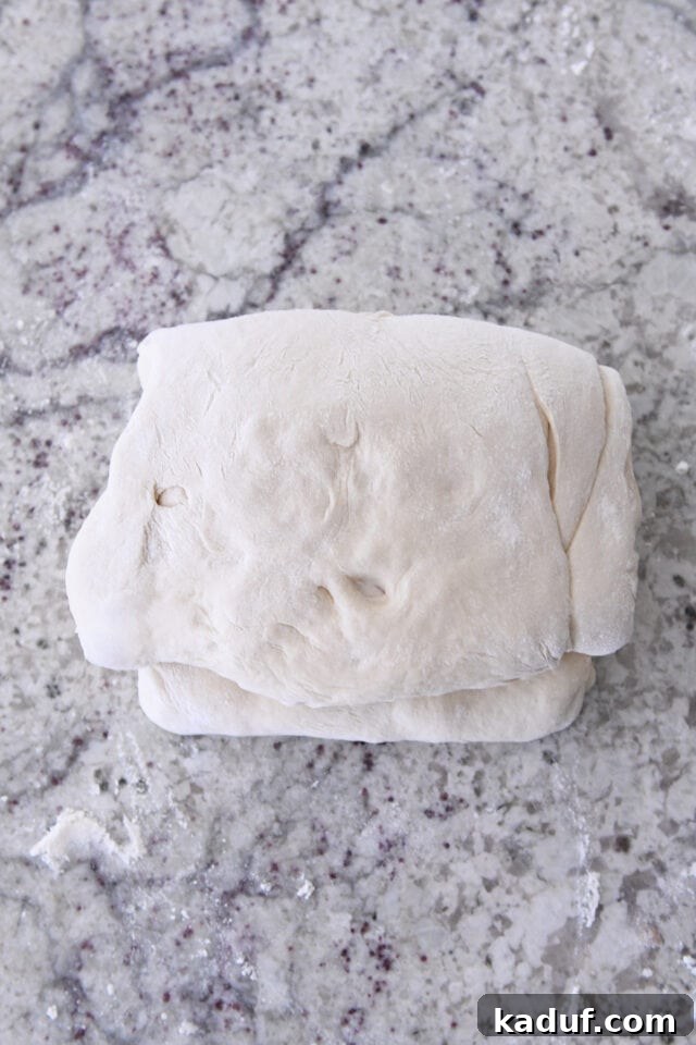 Flaky Cinnamon Croissant Swirl 13 The final folded dough for cinnamon sugar croissant bread, compact and ready for its last shaping.