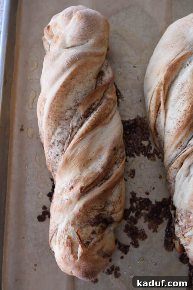 Flaky Cinnamon Croissant Swirl 19 A freshly baked loaf of cinnamon sugar twisted croissant bread, golden-brown and beautifully risen.