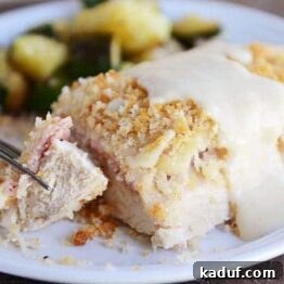 Gourmet Chicken Cordon Bleu Made Simple 5 A close-up of a chicken cordon bleu portion with creamy sauce, ready to be served.