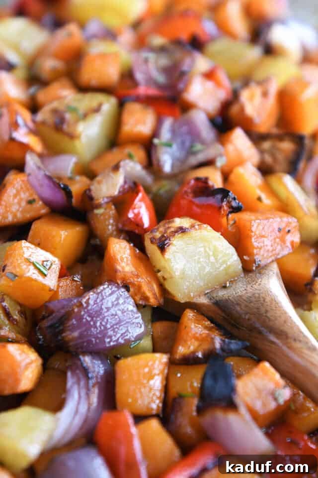 Hearty Balsamic Glazed Root Vegetables 7 A close-up of the roasted potatoes, red onions, red bell peppers, and butternut squash, showcasing their beautiful caramelization on a sheet pan.