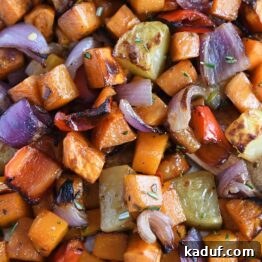Hearty Balsamic Glazed Root Vegetables 8 Roasted potatoes, red onions, red bell peppers and butternut squash on sheet pan.